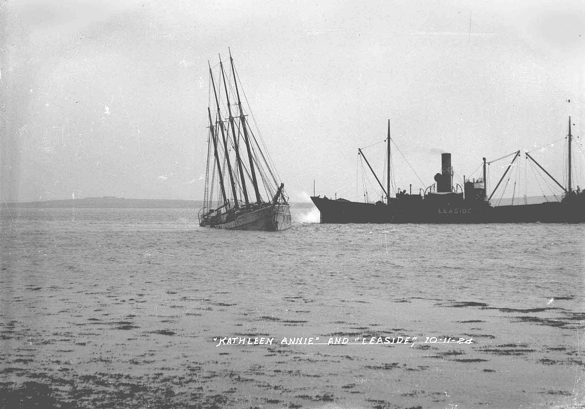 The Kathleen Annie was a four-masted schooner on her way from Bremen to prohibition America when she ran aground off Eday in September 1924. These photos by Tom Kent shows her in Kirkwall Bay shortly before her grounding, then a few months later as her cargo was being salvaged.