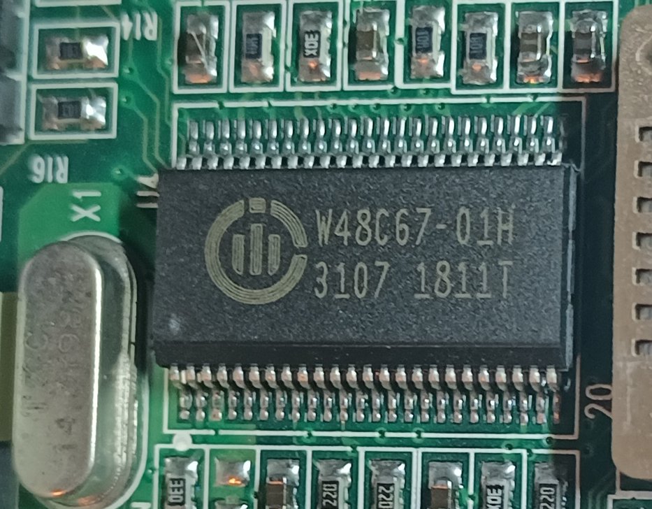 Over near one of the EEPROM chips we've got this W48C67-01H. That's a clock generator for Pentium & Pentium II chips.