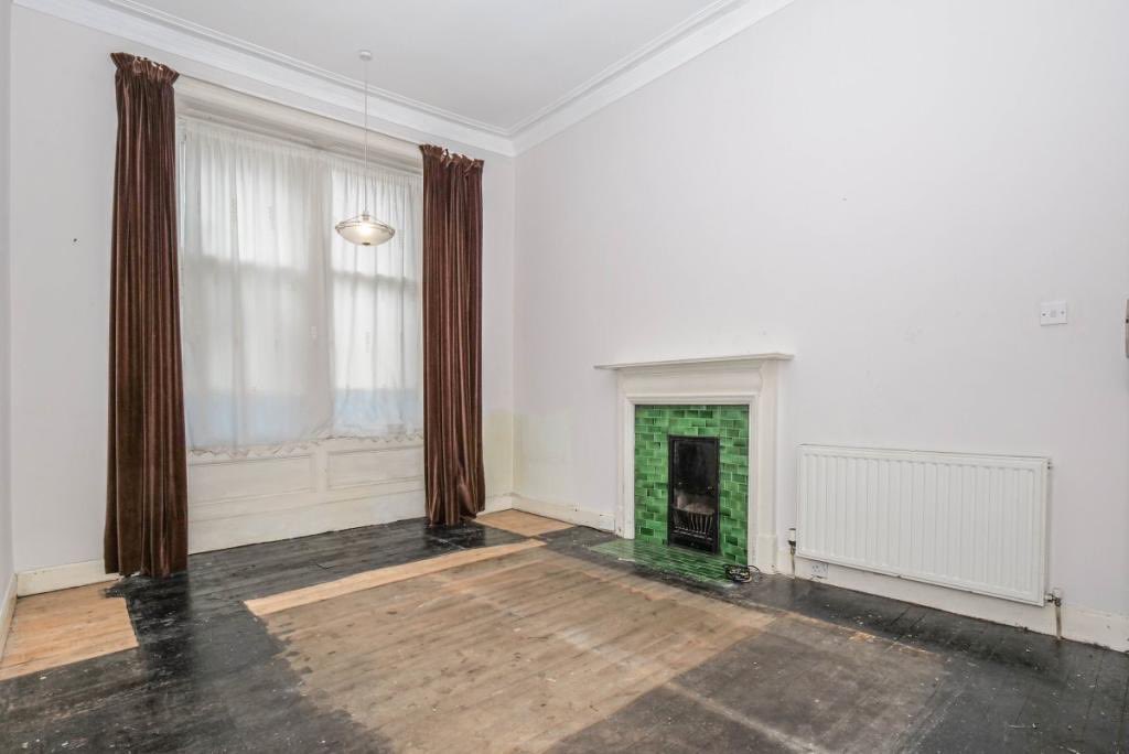 Turned this room into an office-come-movie room (again, sofa incoming).The original fireplaces in this place are 