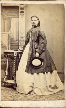 Between 1862-68 the crinoline cages, rather than being equally circular all the way round, shifted the emphasis to the back of the dress, as can be seen in KLNTY2020.130, KLNTY2020.166 & in the 1866 wedding photo of Northenders Thomas Senter & Elizabeth Bone [TY2007.6651]. [3/20]