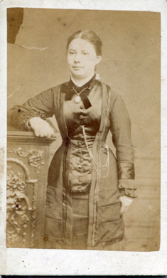 c.1876 Alexandra, Princess of Wales made the ‘princess-line’ silhouette fashionable. Using vertical tucks & darts, rather than a horizontal waist seam. Corsets were tighter & lengthened over the hips. Short curly fringes also became popular. [KLNTY2020.202 & KLNTY2020.203] [8/20]