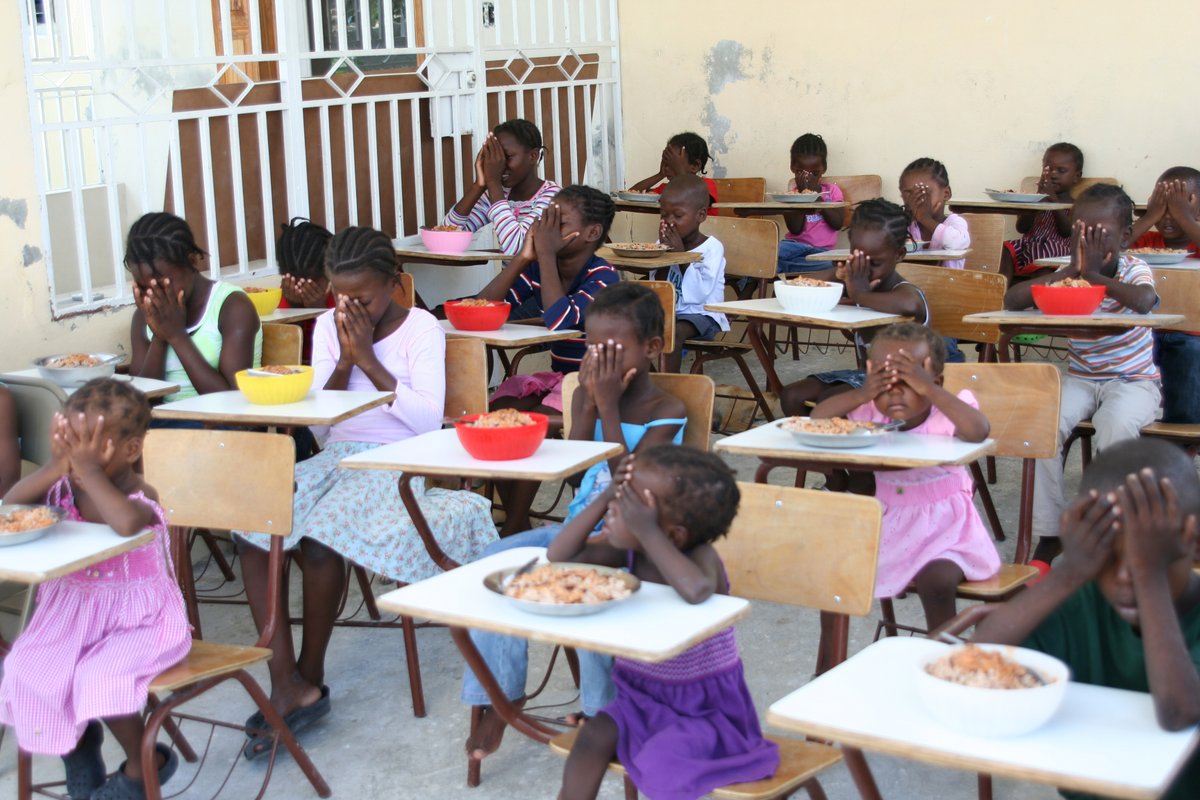 CHFpoverty's tweet photo. Orphans are among the most vulnerable in any society. The church cares for their needs by providing food, shelter, clothing, education, and loving care. These orphans in Haiti thank God for their meal - acknowledging Him as the giver of all good things. #Haiti #orphans #prayer https://t.co/mM2Ykyt943
