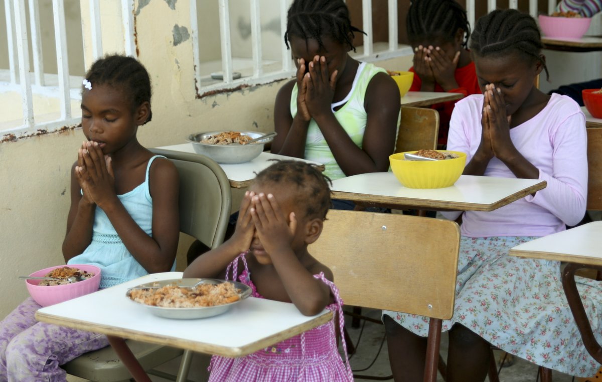 CHFpoverty's tweet photo. Orphans are among the most vulnerable in any society. The church cares for their needs by providing food, shelter, clothing, education, and loving care. These orphans in Haiti thank God for their meal - acknowledging Him as the giver of all good things. #Haiti #orphans #prayer https://t.co/mM2Ykyt943