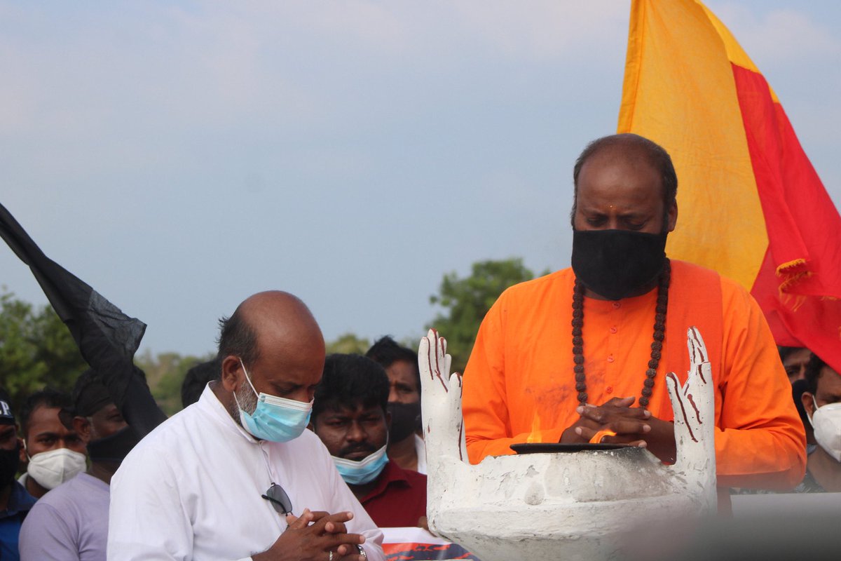 TamilGuardian's tweet photo. Pottuvil to Polikandi protesters reached Mullivaikkal amidst heightened security presence and intimidation. They stopped off at the Mullivaikkal memorial to pay their respects. https://t.co/XavSHKRsvX