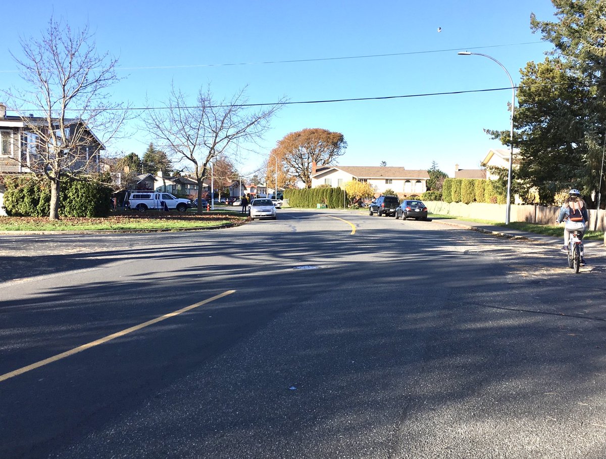 Note how wide Larchwood was/is: btwn 11 & 12.5M.  No new curbs were built, yet enuf space for new bike lanes, generous concrete/planted islands & striped voids. And car lanes still work! Resulting design reduces speeding – more so than the new posted limit of 40km. 4/