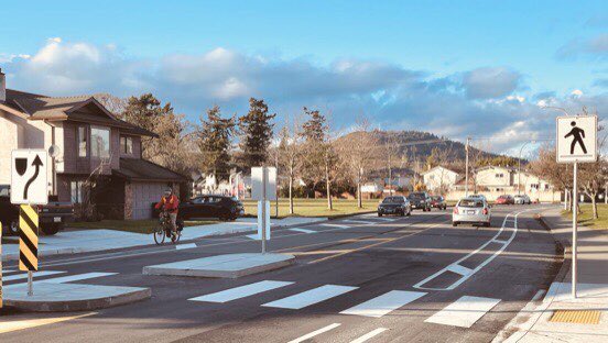 Design incl. parking protected lanes (between driveways). On-street parking pushed out, effectively narrowing overall space & slowing down (most) drivers. There’s room for improvement: e.g. some additional bollards. On west side, look where some folks now walk....6/