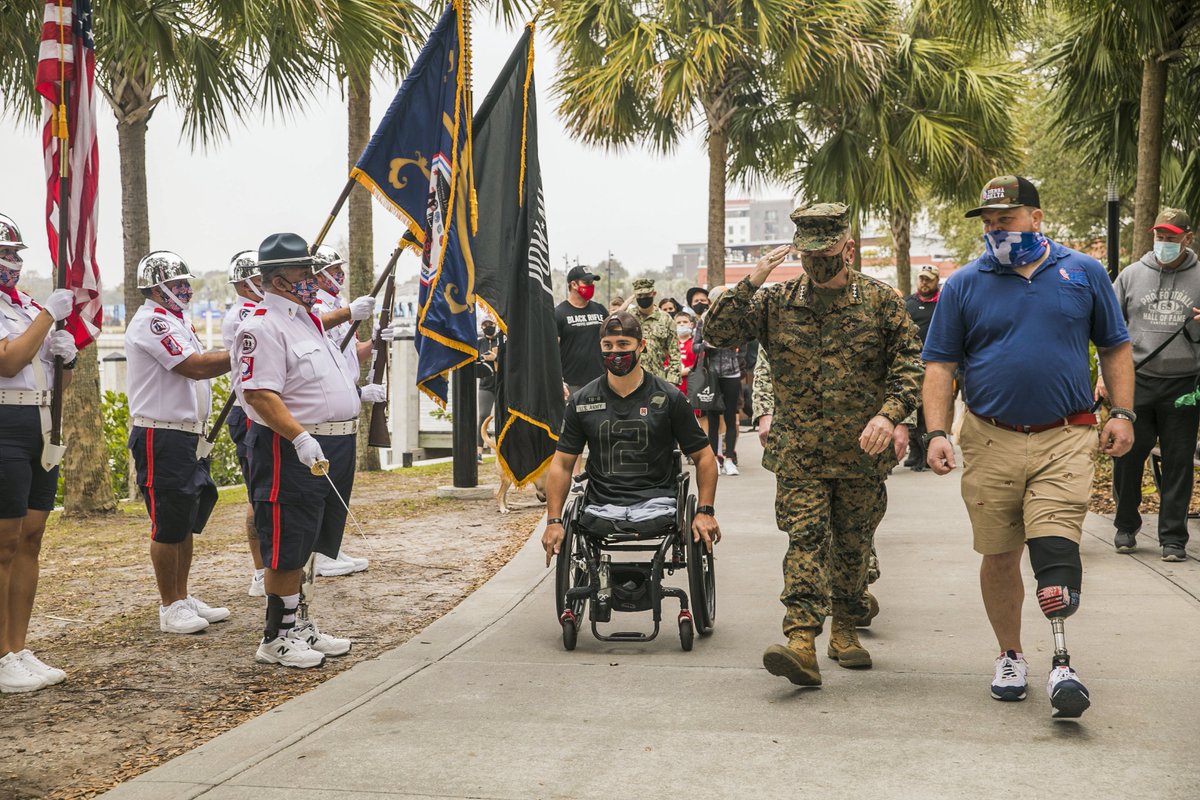 CENTCOM's tweet image. Before the big game, Gen. Frank McKenzie #CENTCOMCDR and Fleet Master Chief James Herdel #CENTCOM Senior Enlisted Leader helped raise awareness of the need to provide more service dogs for veterans at the #Tampa riverwalk this morning. @SierraDeltaDogs #servicedogsforveterans