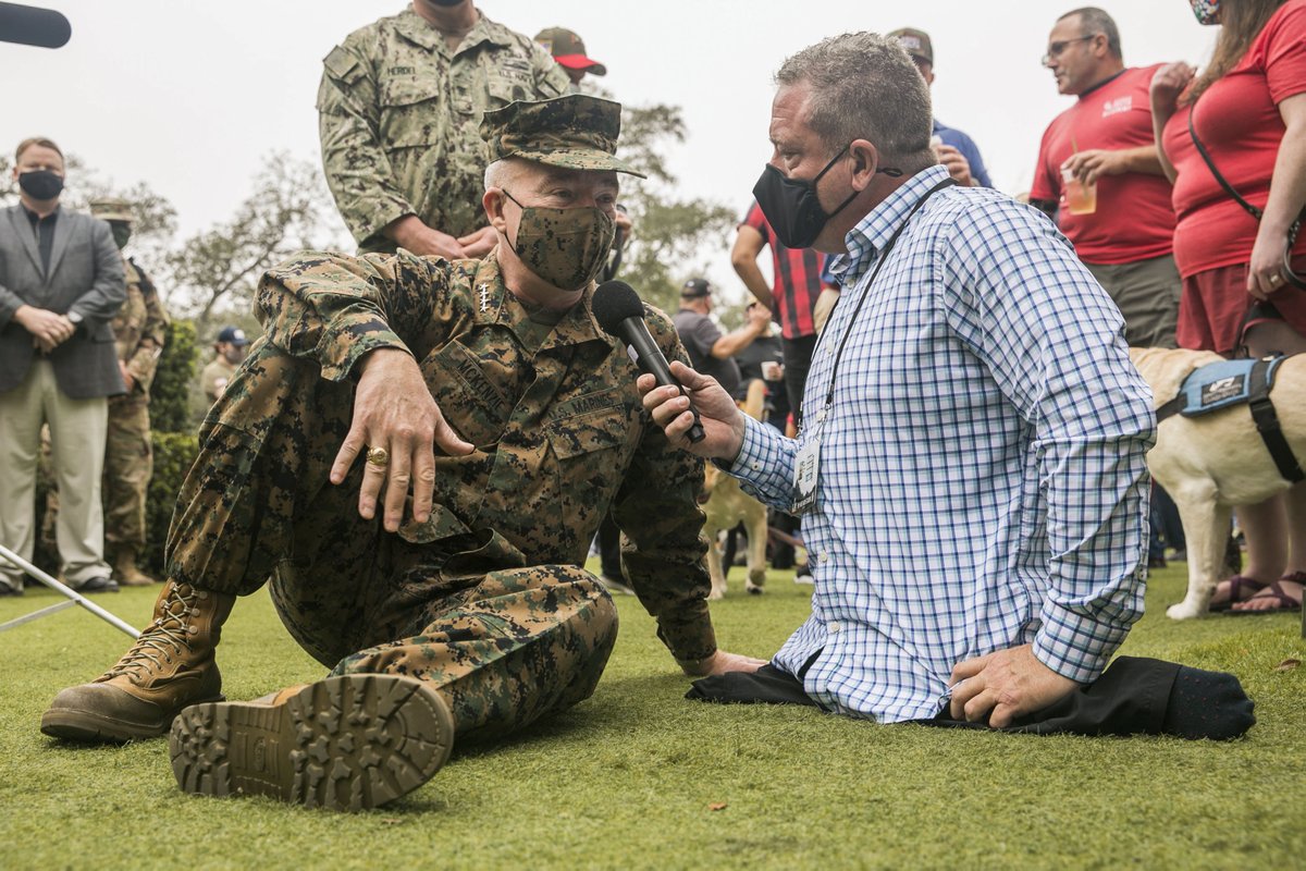 CENTCOM's tweet image. Before the big game, Gen. Frank McKenzie #CENTCOMCDR and Fleet Master Chief James Herdel #CENTCOM Senior Enlisted Leader helped raise awareness of the need to provide more service dogs for veterans at the #Tampa riverwalk this morning. @SierraDeltaDogs #servicedogsforveterans