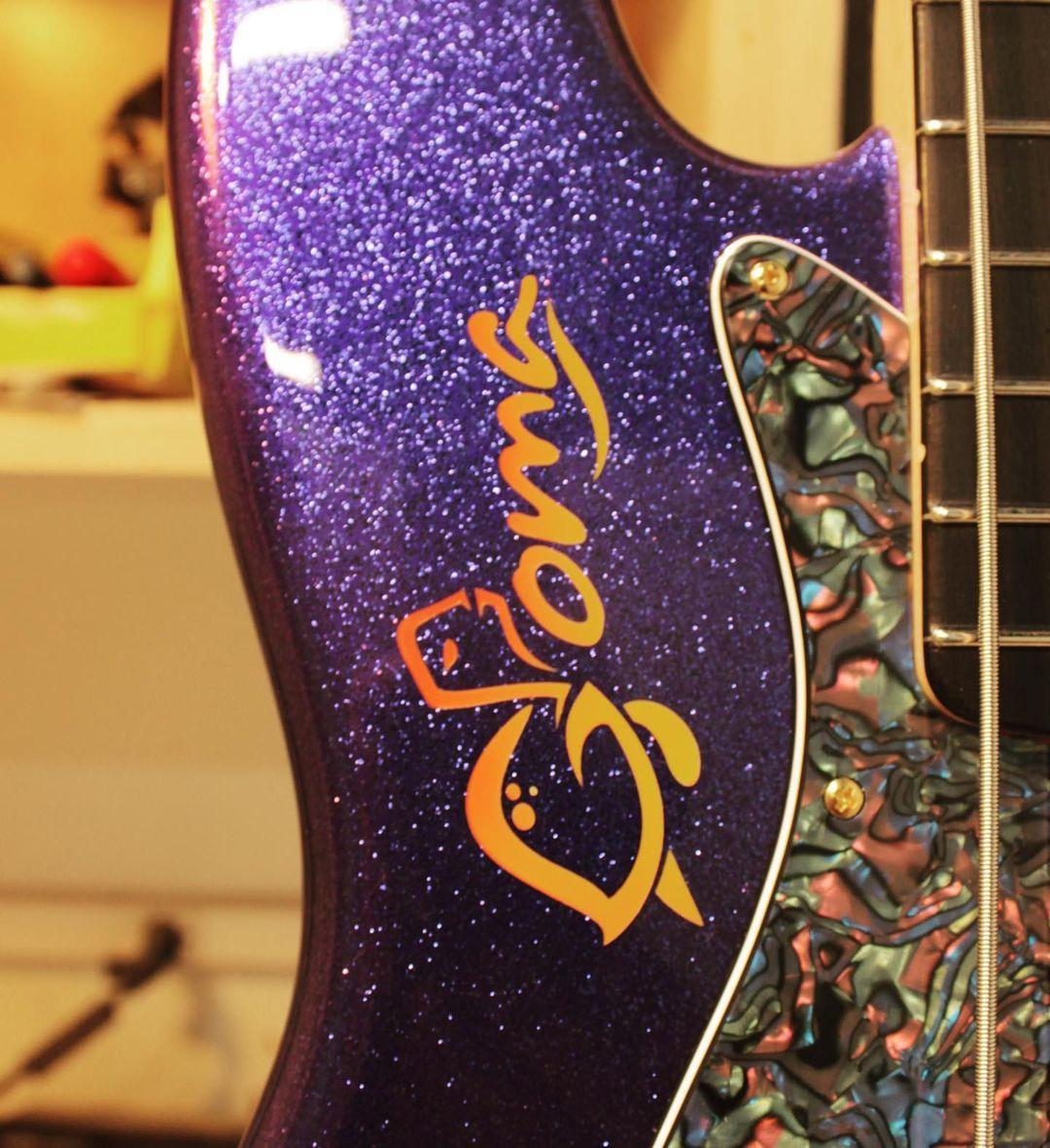 Check out this '64 Jazz Bass built by Vince Van Trigt for <a href="/9ChrisGoma/">Goma</a>. Purple sparkle w. matching peg, gold hardware w. P Bass knobs + cream PUP covers, Josefina Campos hand-wound '60s Jazz Bass PUPs, abalone celluloid guard, signature logo airbrushed on the body in sunset burst.