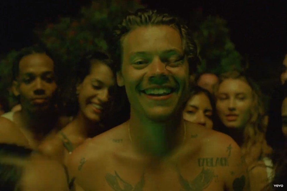 In the music video Harry is surrounded by women AND men touching him.