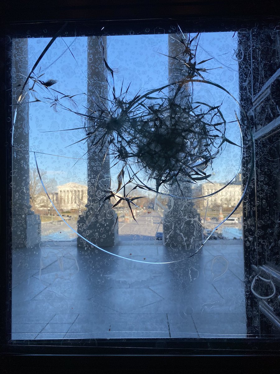 SYMBOL OF THREAT: This shattered window on the center doors of the Capitol is the last remaining major damage I saw left as I walked around the Capitol last night. It remains as a symbol of the hate that penetrated our democracy and flooded inside.