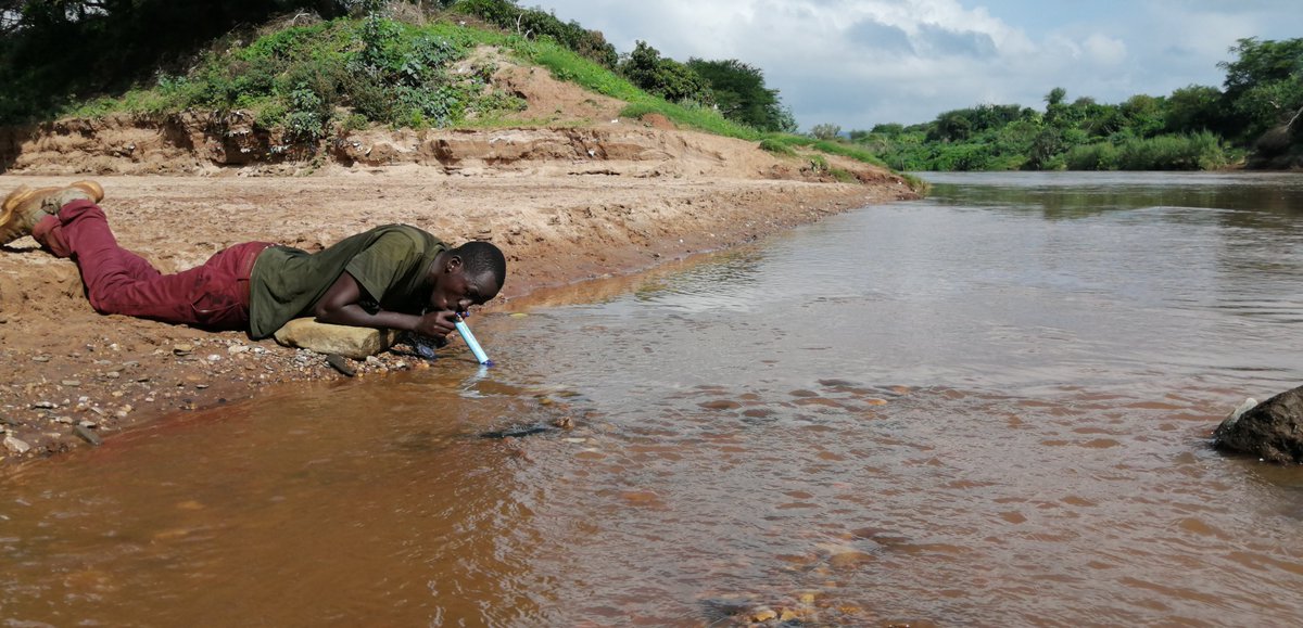InsideNatGeo's tweet photo. “By day five, we had run out of clean drinking water and had no option but to drink from the heavily polluted Athi River itself,” said Alberto. Here, expedition member Mario Kuraki uses a device called a LifeStraw to filter water directly from Athi River. Photo: Alberto Borges https://t.co/zclMkNyCrL