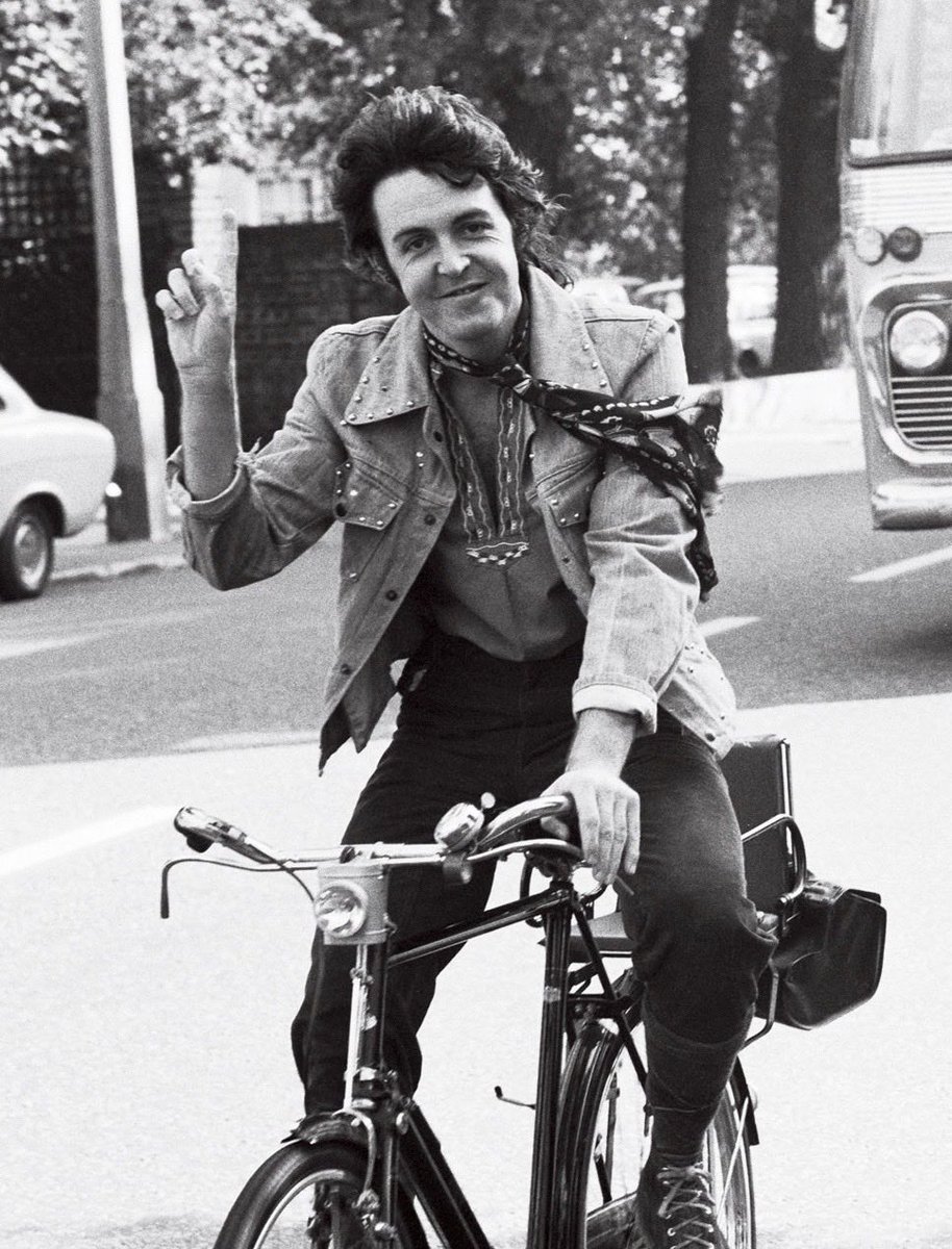 Paul McCartney on a bike.