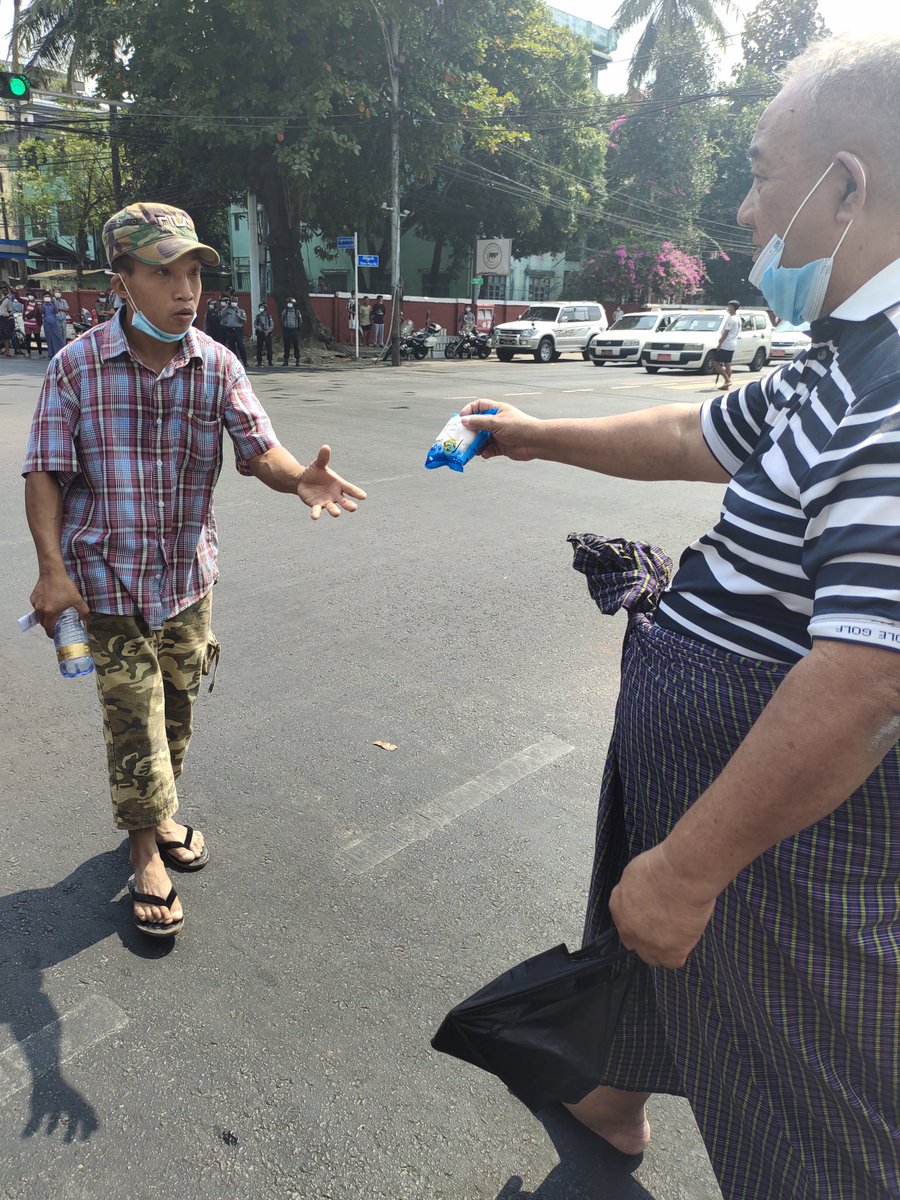 The people are organized. Water and food are bing handed out. There are others collecting the trash.