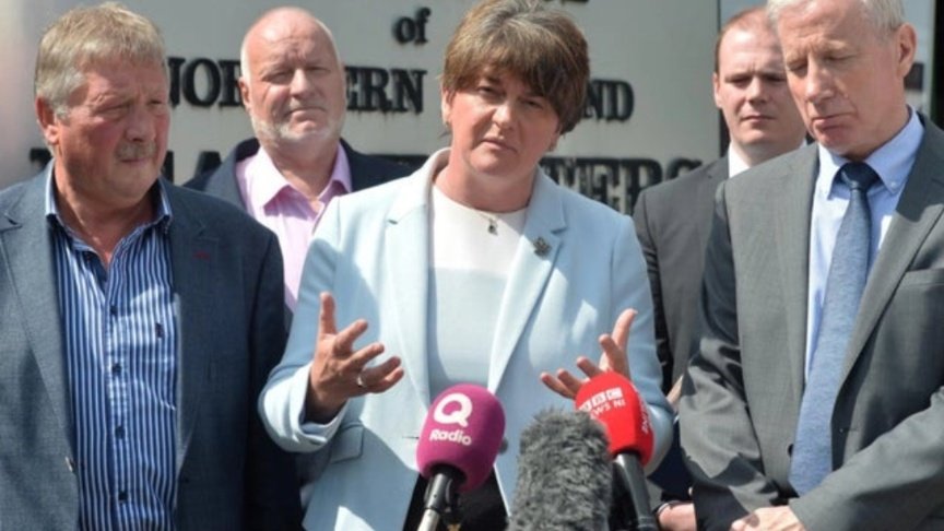 Arlene Foster announcing the February DUP Troll of the Month to winner Gregory Campbell, congratulated by last month's winner Sammy Wilson.