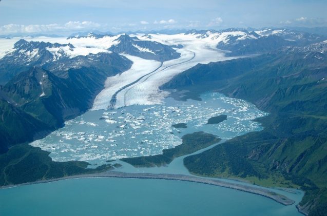 2. Glaciers tend to erode the land on which they "flow". This can form depressions which fill with water when the glacier melts. This is called a glacial lake. It looks like this:(Source:  https://blogs.ei.columbia.edu/2018/05/21/climate-change-glacial-lake-outburst-floods/)