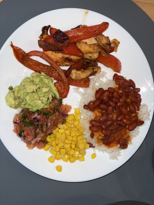 Dinner has been served. Grilled chicken with peppers and onion, guacamole, pico de Gallo and corn and