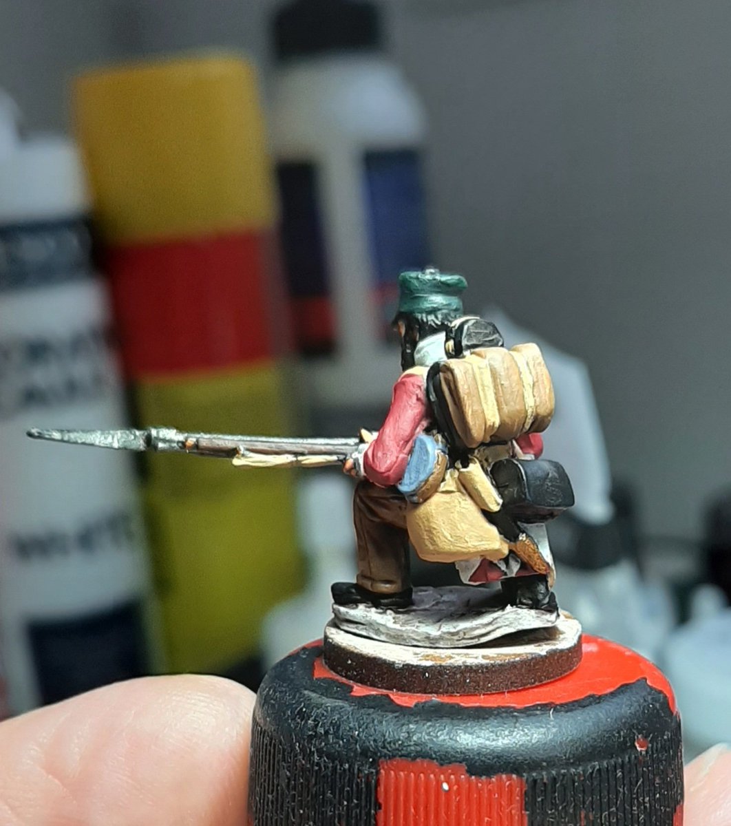 Next we take the colours up a level, hopefully you can see a little more depth, to add to the weathering the white on the coat will be left a light grey, initial woodgrain is added to the musket and flesh is painted onto hands and face.