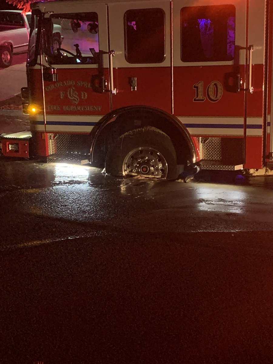 CSFDPIO's tweet photo. Close call for Engine 10 this morning. While at a structure fire, Engine 10 sank into a sinkhole caused by a water main break. No injuries to FF’s and minor damage to the bumper. Engine 10 is the CSFD’s newest @PierceMfg that went into service 1/22/2021. #coloradospringsfire https://t.co/r9iVFzmVIY