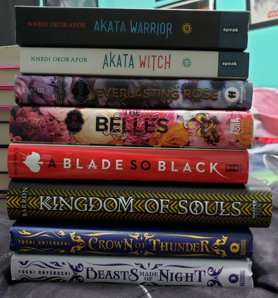Stormraven24's tweet image. I think I've got more on the shelves, but there's so much stuff in the way I can't get to them. I know I've got A Phoenix First Must Burn, but it's hiding 😞

Anyway, here are my stacks for #MelaninInYA! @melanin_ya