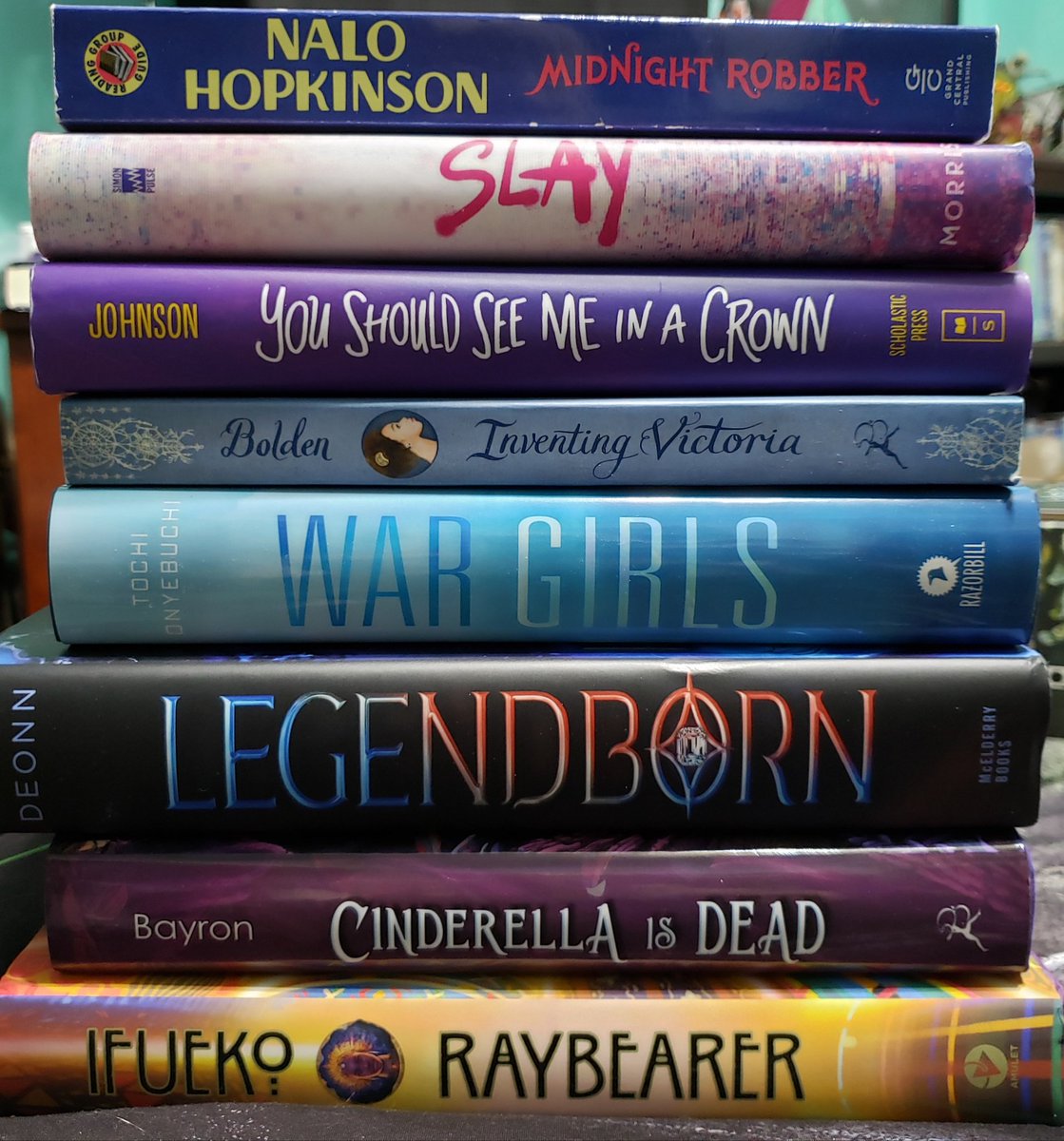 Stormraven24's tweet image. I think I've got more on the shelves, but there's so much stuff in the way I can't get to them. I know I've got A Phoenix First Must Burn, but it's hiding 😞

Anyway, here are my stacks for #MelaninInYA! @melanin_ya