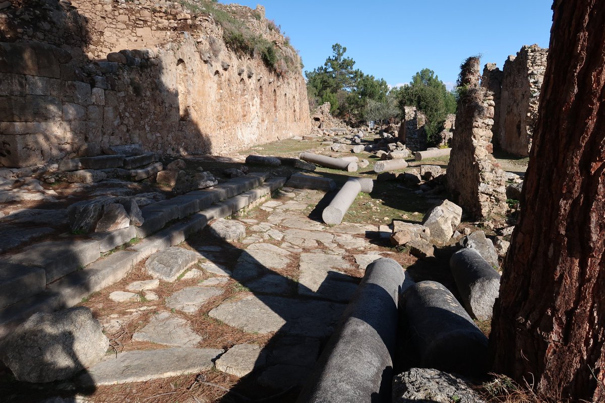 3/10 A few more pictures of Syedra's 250 metre long main street which runs from a heroon at one end to some inscriptions at the other heralding the performances of athletes. The buildings along one side had two storeys and several are excavated. Many pillars lie around.