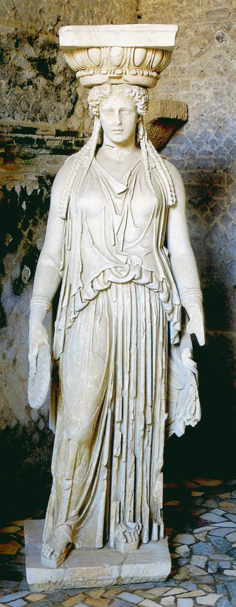 Actually, the Fat Lady's attire is an interpretation of the Caryatid's dress (shown here by an original kore in Athens and a better preserved Hadrianic copy from Tivoli). Her chiton has been adapted by adding one button turning it from a sleeveless into a loosely sleeved one.