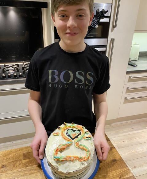 Burnley_High's tweet photo. Lewis Haworth is a lock-down legend, he has raised a fantastic £25 for mind. His cake included a mental health logo and rainbow layers throughout! He said it was mouth-watering! We are very proud of Lewis for raising awareness for children's mental health week!!  #BHSBAKEOFF https://t.co/RpDwfwkXn4