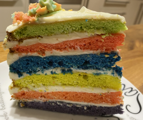 Burnley_High's tweet photo. Lewis Haworth is a lock-down legend, he has raised a fantastic £25 for mind. His cake included a mental health logo and rainbow layers throughout! He said it was mouth-watering! We are very proud of Lewis for raising awareness for children's mental health week!!  #BHSBAKEOFF https://t.co/RpDwfwkXn4