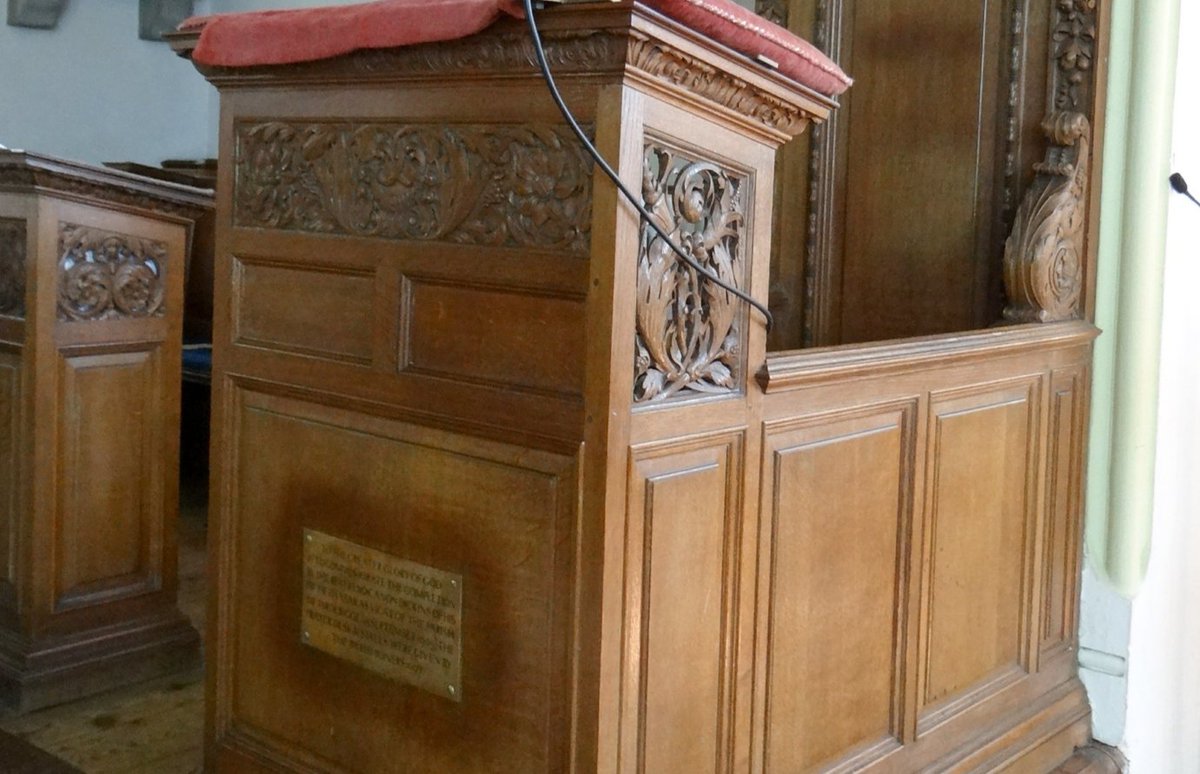 Returning to the chancel, the carved oak stalls and canopied priest's desk are also designed & detailed in a manner to respect the Georgian church. A brass plaque records the fact that they were the gift of the parishioners to commemorate their vicar's 50 years of incumbency.