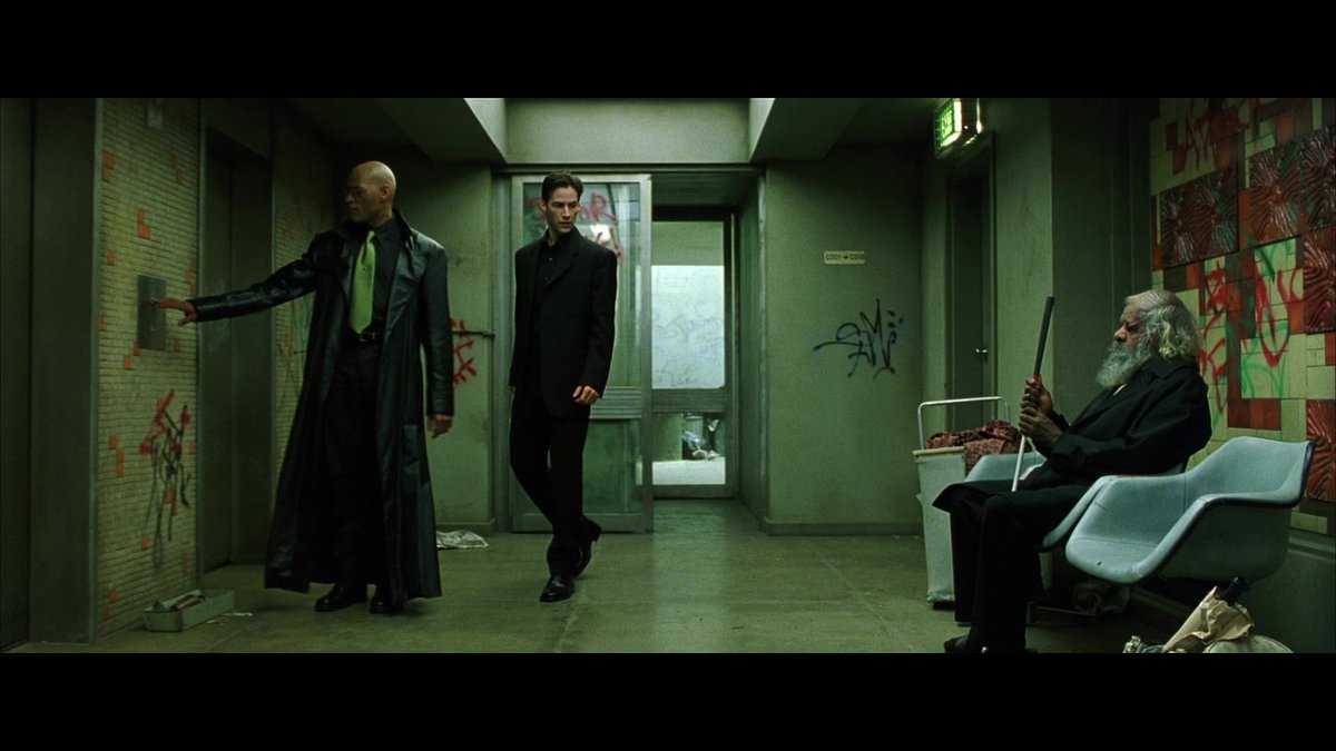 This guy appears outside the Oracle's apartment. Maybe I'm reading too much into it, but... Morpheus wears mirrored sunglasses, this guy is blind. He & Morphus recognize each other. They exude Zen-like calm.The ancient seer Morpheus will become (he's already on the path).17/