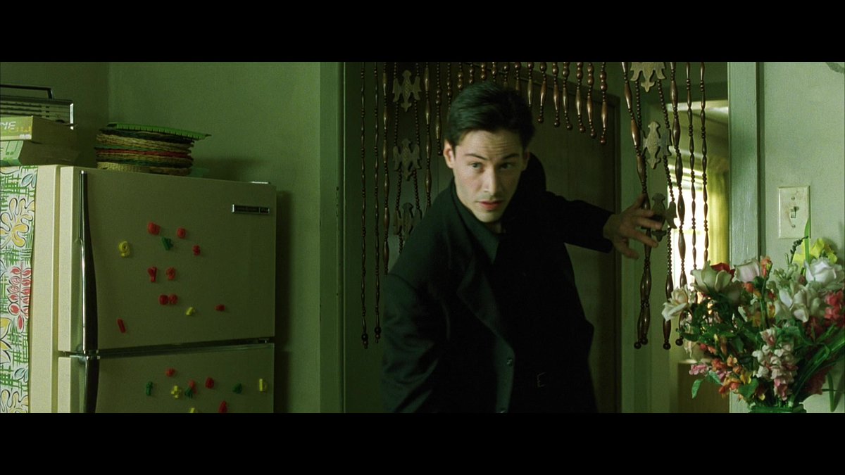 And more patterns, this time inside the Oracle's apartment.I'd argue the beads at the kitchen entrance form a kind of 1-0-1 pattern, with Neo in the middle. Also temple-like entrance.Am I pattern-finding? Or pattern-matching? W/the Wachowskis, I am never sure.19/