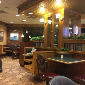 nonstandardmcd's tweet photo. the original decor of this mcdonald's, referred to locally as "victorian", was eclectic - featuring false bookcases, wall sconce lighting, upholstered seating, portraits, and even themed trash cans. https://t.co/eZjpwxRpR6