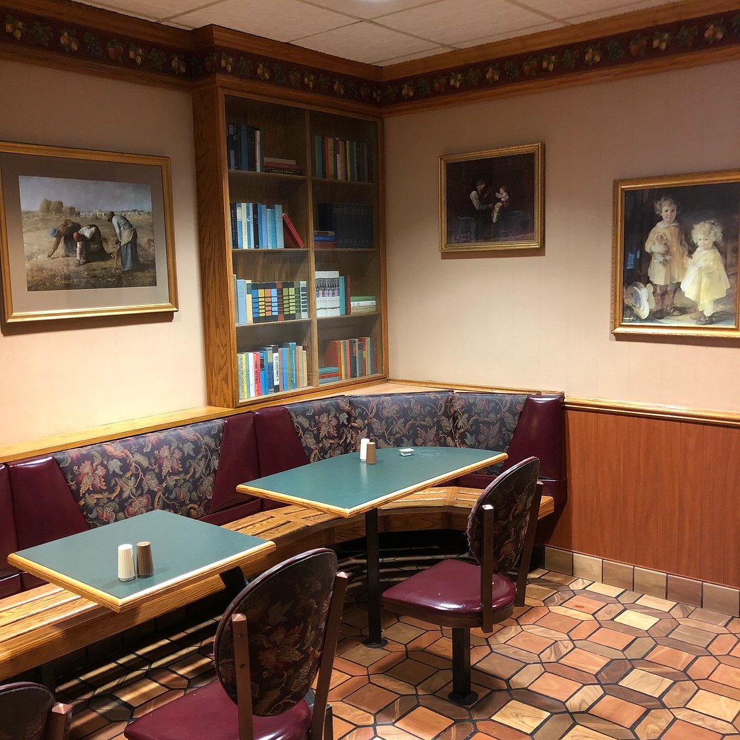 nonstandardmcd's tweet photo. the original decor of this mcdonald's, referred to locally as "victorian", was eclectic - featuring false bookcases, wall sconce lighting, upholstered seating, portraits, and even themed trash cans. https://t.co/eZjpwxRpR6