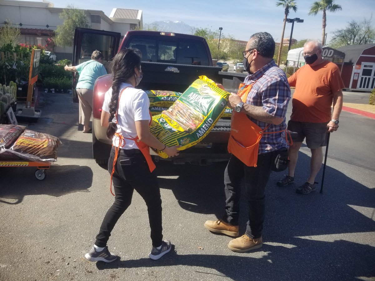 Teaming up to load bags of soil and mulch #teamrancho #safely