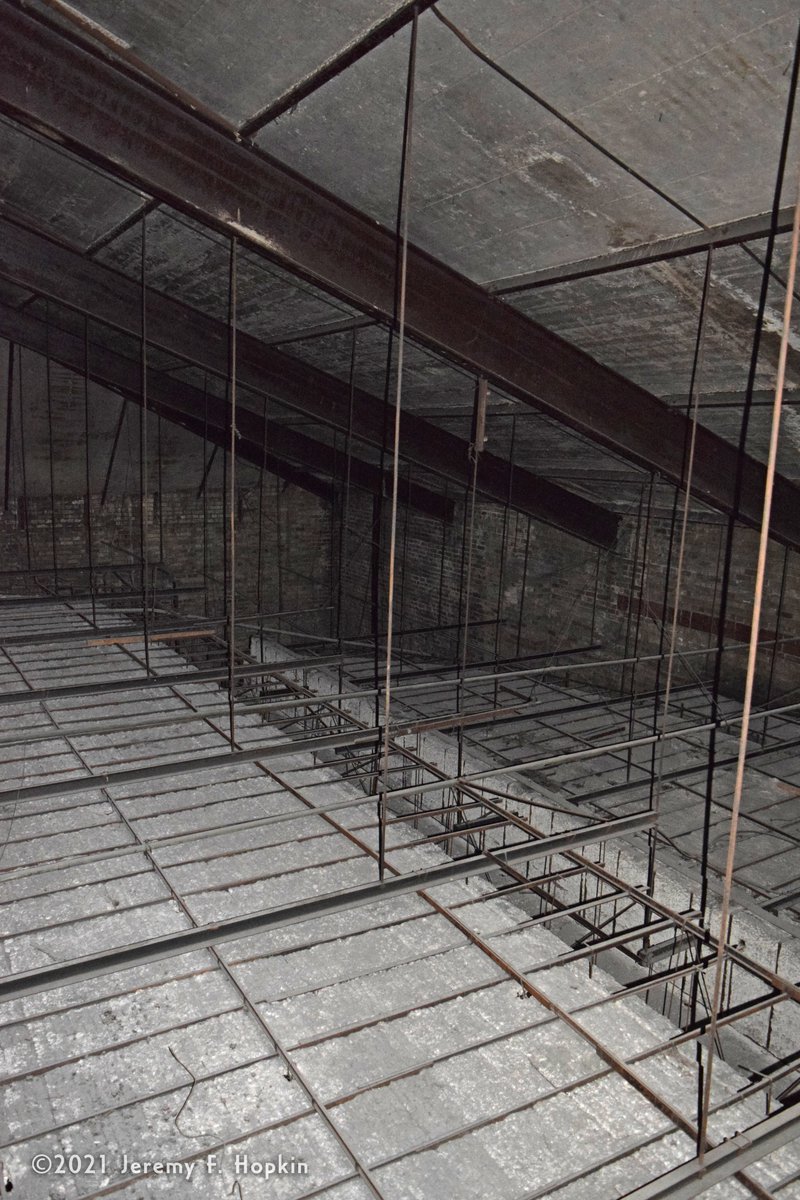 Heading west from where we started, we realize that the floor up here is actually the top side of the hall's plaster ceiling. As we approach the south west corner of the attic, the ceiling / floor tapers north & disappears! Make sure to cling to the metal truss as we pass by.