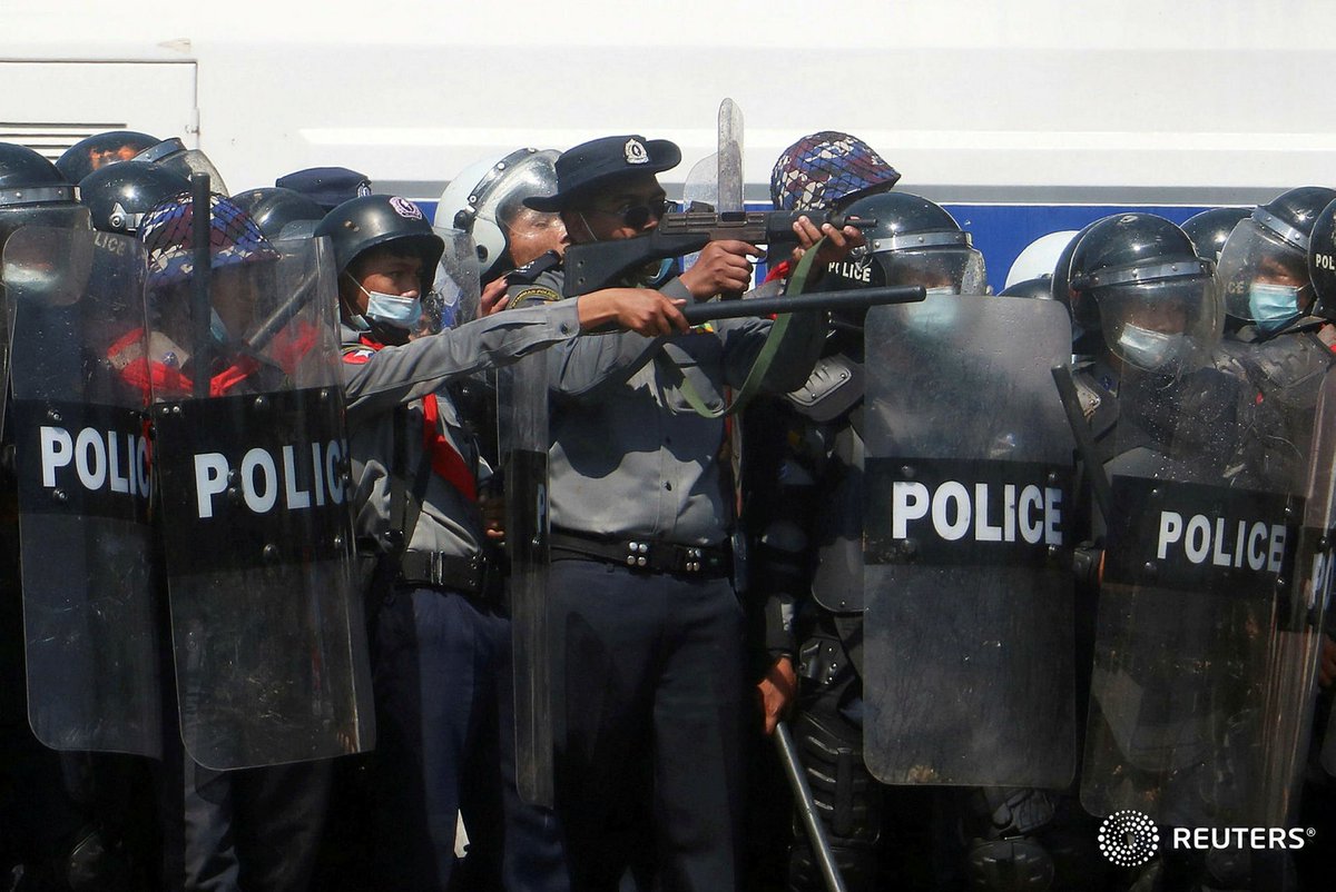 A police officer aims during clashes with protestors rallying against the military coup and demanding the release of elected leader Aung San Suu Kyi, in Naypyitaw, Myanmar, February 9, 2021. REUTERS/Stringer  #WhatsHappeningInMyanmar  #Coup9Feb