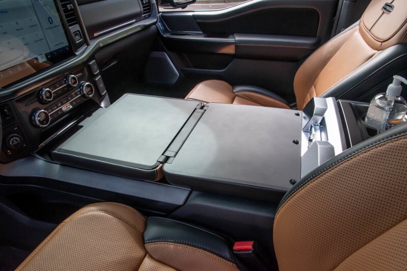 StouffvilleFord's tweet photo. To further celebrate Truck Month, let's start off the day with this #TechTuesday— Our 2021 F-150 fold down console. Working from home has been a common new daily for many of us these days— but have you heard of working in the comfort of your own truck? https://t.co/ioGO9WOyyQ