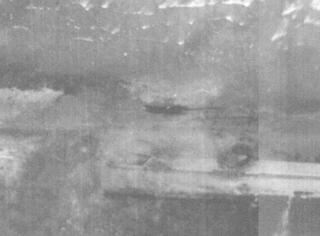 It's actually two separate but sequential images that I've inexpertly stitched together. The only location clue in the book is Gold Jig Red, which I can confirm. These bomb craters appear in other images from D-Day and we can locate the beach exactly.