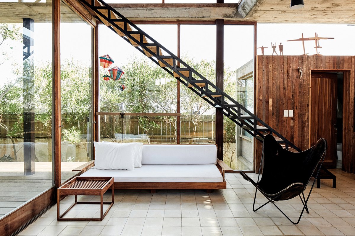 dezeen's tweet photo. Weathered wood and textured concrete feature in Alejandro Sticotti's holiday home in Uruguay: https://t.co/4y8M1oZKw6 https://t.co/2MJD8l5H8I