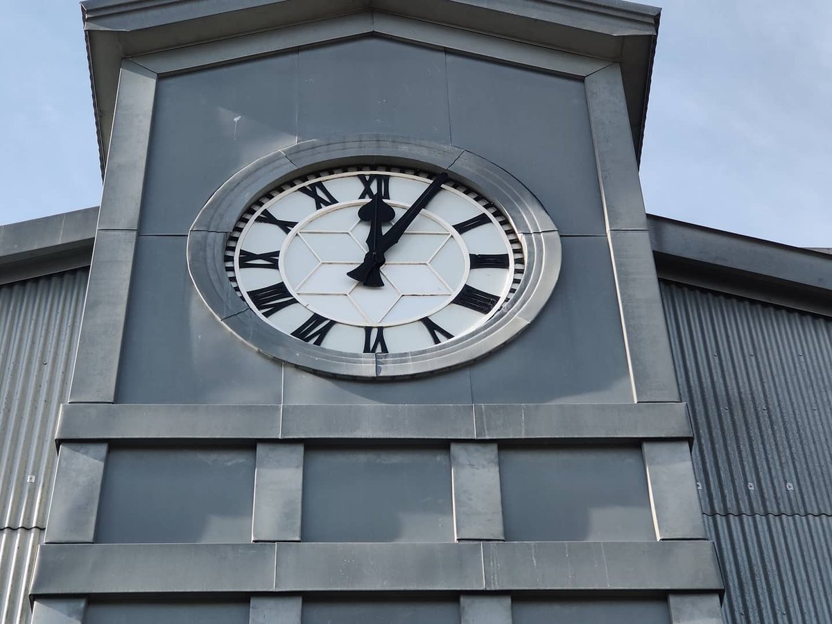 TimeAssured's tweet image. The sun&apos;s back out while Mike installs some new opal glass, the clock over looks Britain&apos;s oldest wind tunnels building that has tested everything from Spitfires to Concorde&apos;s.