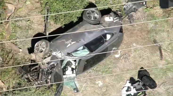Bogs4NY's tweet photo. NBC LA over the scene where Tiger Woods crashed this morning in LA county ... you can see heavy damage to the SUV #nbc4ny https://t.co/lT4KddIqOb