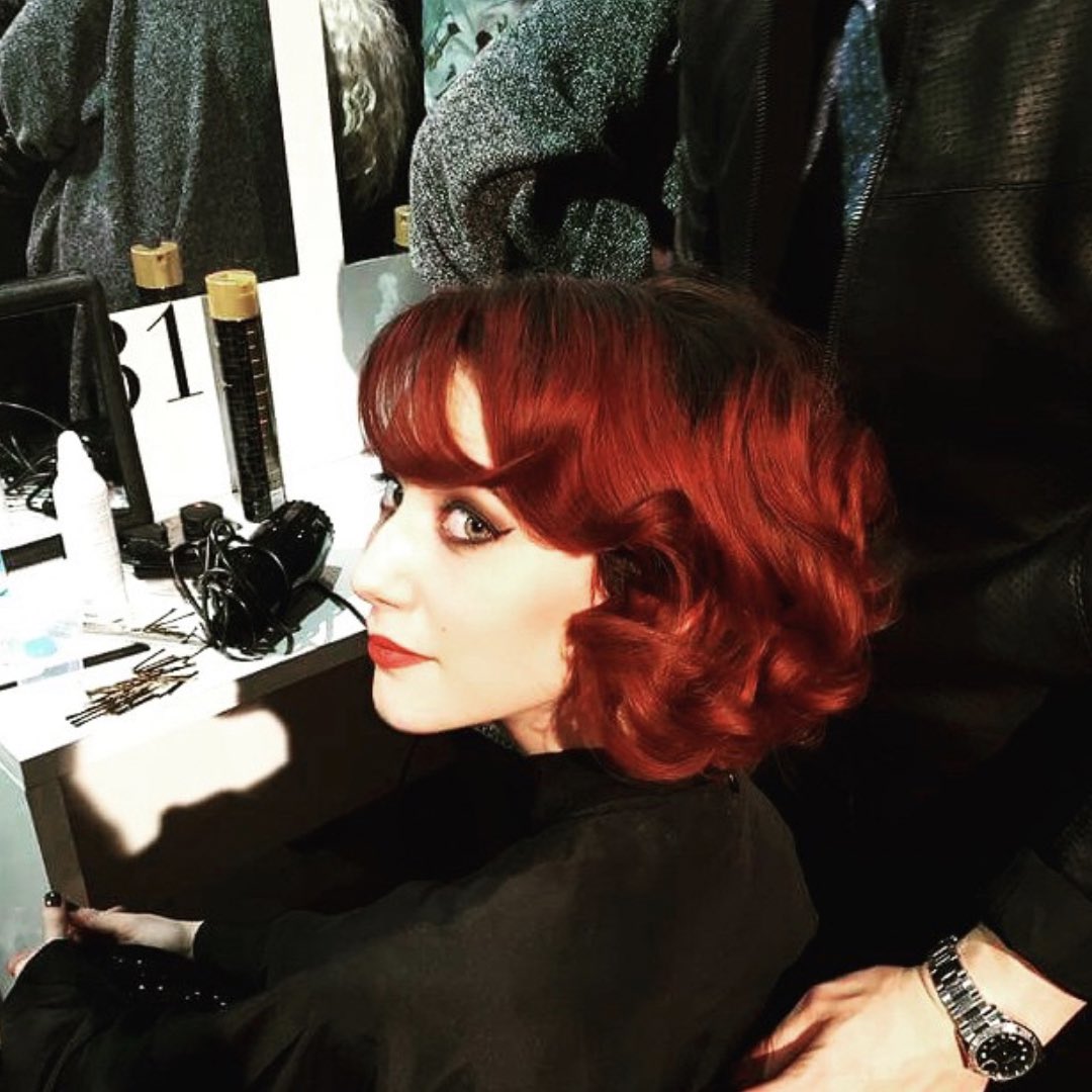 Girl with short, bright red hair