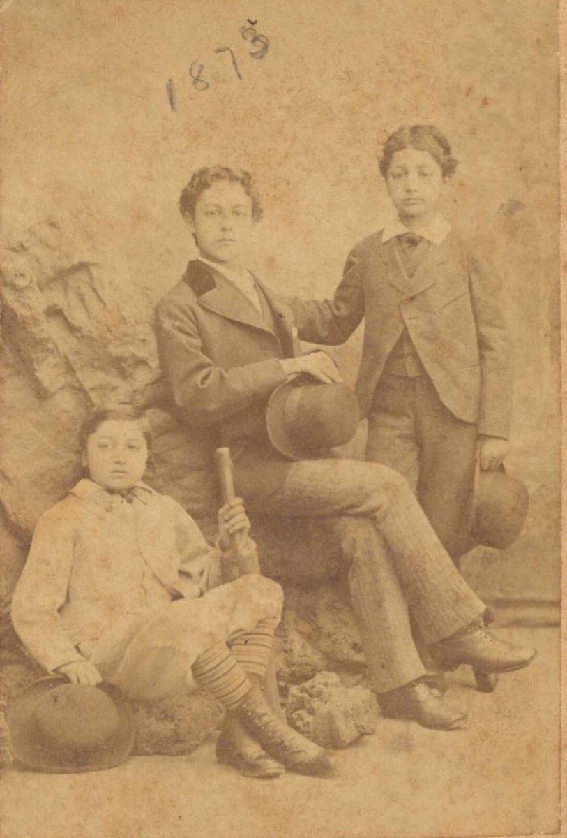 Photograph of the three Cavafy brothers, John, Paul and Constantine (right, aged 10), dressed in suits. John holds a cricket bat. Taken in Liverpool, 1873. Cavafy Archive.