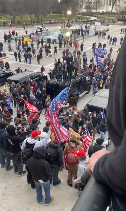 The Parler video was taken on the *EAST* face of the Capitol, on the center stairs. When the camera pans up at :36 and :43 you can see the telltale rectangular pavement design, and the Supreme Court across First Street. The steps she was on lead to the Rotunda entrance.