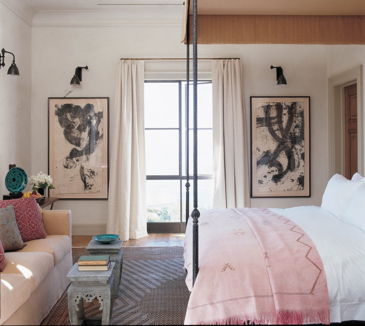 This room, and everything in it, is big in scale. The ceiling is high and the windows are tall, so I brought in strong vertical elements like these 2 Japanese brushstroke paintings and a large steel campaign bed based on an Italian original... Beautiful.