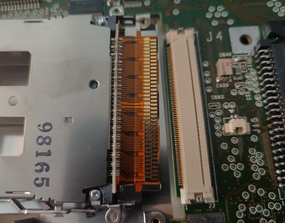 Interesting: I've never seen a PCMCIA slot connect by card-edge-flat-flex before.