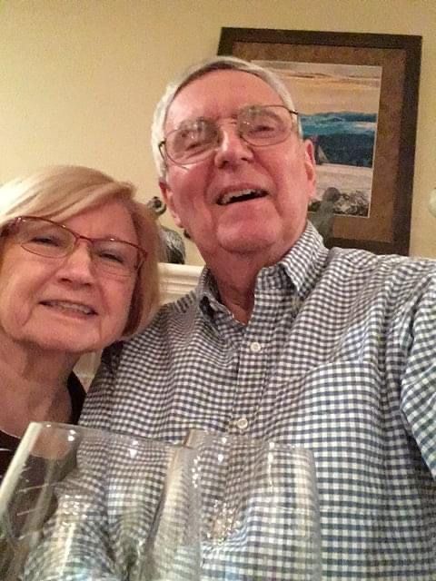 A gray-haired couple take a selfie