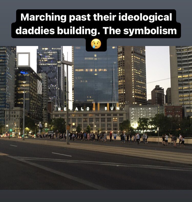 Marching past the herald scum building. You gotta love the poetry in motion here.