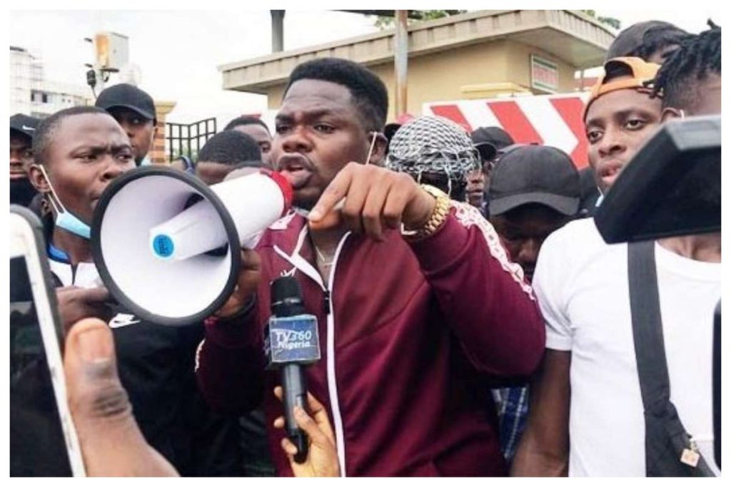 Frame 1: Mr Perfect with a cutlass. This good guy is yet to be arrested. What a role model he is 🙌🏾 Frame 2: Mr Macaroni with a mega phone. He was arrested today. A Hoodlum 😔 This is Nigeria 💔 I Stan the Hoodlum in this picture 💯 #LekkiTollGateProtest #EndSARS